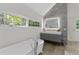 Luxurious bathroom featuring a modern vanity, soaking tub, and large windows for natural light at 6305 River Chase Cir, Atlanta, GA 30328