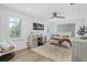 Bright bedroom with hardwood floors, a ceiling fan, and a cozy armchair at 6305 River Chase Cir, Atlanta, GA 30328