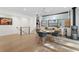 Open dining area with hardwood floors, modern lighting, a fireplace, and staircase at 6305 River Chase Cir, Atlanta, GA 30328