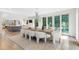 Elegant dining room with modern lighting, hardwood floors, and a sliding glass door to the outdoors at 6305 River Chase Cir, Atlanta, GA 30328