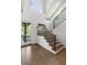 Bright entryway with hardwood floors, staircase with iron railing, and large windows at 6305 River Chase Cir, Atlanta, GA 30328