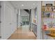 Hallway featuring hardwood floors, a built-in desk, and ample natural light at 6305 River Chase Cir, Atlanta, GA 30328