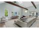 Airy living room featuring wood beams, skylights, large windows, and comfortable seating at 6305 River Chase Cir, Atlanta, GA 30328