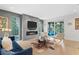 Modern living room with a linear fireplace, large windows, and contemporary furniture at 6305 River Chase Cir, Atlanta, GA 30328