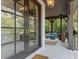 Cozy covered porch with a brick floor, fireplace, and comfortable seating area at 6305 River Chase Cir, Atlanta, GA 30328