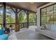 Inviting covered porch featuring a modern fireplace, comfortable seating, and outdoor living space at 6305 River Chase Cir, Atlanta, GA 30328