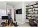 Home office featuring a modern desk, mounted TV, open shelving, and cozy seating area at 2020 Bixby Se St, Atlanta, GA 30317