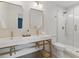 Modern bathroom featuring double vanity, stylish lighting, and tiled shower at 2244 Alpha Dr, Decatur, GA 30032