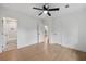 Simple bedroom with fan, wood floors, and access to a tiled bathroom at 2244 Alpha Dr, Decatur, GA 30032