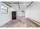 Unfinished garage with a single window, concrete flooring, pegboard, and basic utilities at 3066 Malvern Dr, Snellville, GA 30039