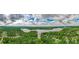 An aerial shot reveals a serene lake surrounded by verdant forests and scattered houses at 4527 Dallas St, Acworth, GA 30101