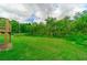 Large backyard featuring a lush green lawn and plenty of mature trees at 4527 Dallas St, Acworth, GA 30101