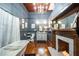 Cozy bathroom with a chandelier, white tub, fireplace, and hardwood floors throughout at 4527 Dallas St, Acworth, GA 30101