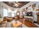 Inviting living room boasts wood floors, detailed ceiling, natural light, and cozy seating area at 4527 Dallas St, Acworth, GA 30101