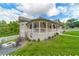Side exterior displaying well-maintained yard, a fire pit with chairs, and classic design elements at 4527 Dallas St, Acworth, GA 30101
