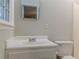 Bright bathroom featuring a vanity with sink, a toilet and a framed mirror at 50 Carriage Trce, Stockbridge, GA 30281