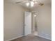 Neutral bedroom features a ceiling fan, a gray carpet, and a white door at 50 Carriage Trce, Stockbridge, GA 30281