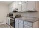 Modern kitchen features stainless steel appliances, granite countertops, and painted cabinets at 50 Carriage Trce, Stockbridge, GA 30281