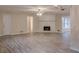 Spacious living room featuring hardwood floors, a fireplace, and ample natural light at 50 Carriage Trce, Stockbridge, GA 30281