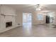 Open-concept living room with vinyl flooring, fireplace, and seamless flow to the kitchen at 50 Carriage Trce, Stockbridge, GA 30281