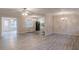 Spacious living room featuring vinyl flooring, modern lighting, and open access to the kitchen and sunroom at 50 Carriage Trce, Stockbridge, GA 30281