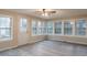 Light-filled sunroom with many windows and vinyl flooring, perfect for relaxation and entertaining at 50 Carriage Trce, Stockbridge, GA 30281