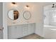Elegant bathroom featuring dual sinks, modern fixtures, and a well-lit, neutral-toned design at 3006 Sea Aster Way, Buford, GA 30519
