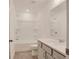 Bright bathroom features a tiled floor, toilet, combination tub and shower, and single sink vanity at 3006 Sea Aster Way, Buford, GA 30519