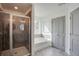 Clean bathroom with tiled shower, soaking tub, storage shelves, and a stylish neutral color palette at 3006 Sea Aster Way, Buford, GA 30519