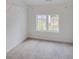 Spacious walk-in closet with neutral paint, carpet, and a large window to let natural light in at 3006 Sea Aster Way, Buford, GA 30519