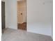 View into tiled laundry area from a bedroom with gray walls and neutral carpet in a clean new home at 3006 Sea Aster Way, Buford, GA 30519