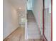 Bright entryway featuring light wood flooring, a staircase with gray carpeting, and an open view into a living space at 3006 Sea Aster Way, Buford, GA 30519