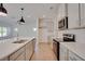 Bright kitchen features stainless appliances, granite counters, an island with sink, and pendant lighting at 3006 Sea Aster Way, Buford, GA 30519