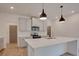 Modern kitchen with white cabinetry, stainless steel appliances, a white subway tile backsplash, and island seating at 3006 Sea Aster Way, Buford, GA 30519