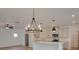 Bright, open kitchen layout featuring an island, modern lighting, and stainless steel appliances at 3006 Sea Aster Way, Buford, GA 30519