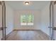Clean office space with hardwood floors, a large window, and natural light at 3006 Sea Aster Way, Buford, GA 30519