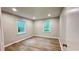 A serene bedroom with two windows and new floors at 336 Shady Lane Cir, Canton, GA 30115
