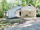 Charming home with an open carport, fresh landscaping, and a stairway leading to a side entrance at 336 Shady Lane Cir, Canton, GA 30115
