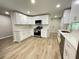 Modern kitchen featuring white cabinets, stainless steel appliances, and sleek countertops at 336 Shady Lane Cir, Canton, GA 30115