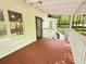 Spacious wooden porch with white railings and door access to the white home at 336 Shady Lane Cir, Canton, GA 30115