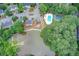 Aerial view of a community with a lake, pool, and tennis courts, showcasing the neighborhood's amenities and layout at 3999 Bayside Cir, Doraville, GA 30340