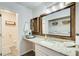 Well-lit bathroom features a granite countertop, modern mirror and linen storage at 3999 Bayside Cir, Doraville, GA 30340