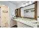 Updated bathroom featuring granite countertops, decorative mirror, and adjacent laundry area at 3999 Bayside Cir, Doraville, GA 30340