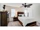 Bedroom features wood furniture set, ceiling fan, bright windows and plush neutral carpeting at 3999 Bayside Cir, Doraville, GA 30340