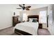 Bedroom showcases wood furniture set, ceiling fan, bright windows and plush neutral carpeting at 3999 Bayside Cir, Doraville, GA 30340