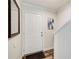 Bright entryway with wood-look flooring, mirror, and white door leading upstairs at 3999 Bayside Cir, Doraville, GA 30340