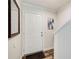 Clean entryway with wood floors, white walls, and decorative mirror and wall art at 3999 Bayside Cir, Doraville, GA 30340