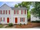 Charming two-story townhouse featuring light gray siding and red shutters, creating a welcoming curb appeal at 3999 Bayside Cir, Doraville, GA 30340