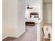 Hallway with neutral carpet leading to bedroom that features a ceiling fan and accent furniture at 3999 Bayside Cir, Doraville, GA 30340