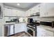 Modern kitchen with white cabinets, stainless steel appliances, and granite countertops at 3999 Bayside Cir, Doraville, GA 30340